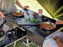 The KitchenBox all in one camping kitchen being used for a mealtime on a TentBoxing trip. 