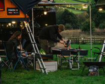 KitchenBox couple sitting cooking dinner at a campsite