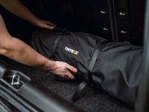 Person demonstrating how to store the Lite XL Living Pod in the boot of a car