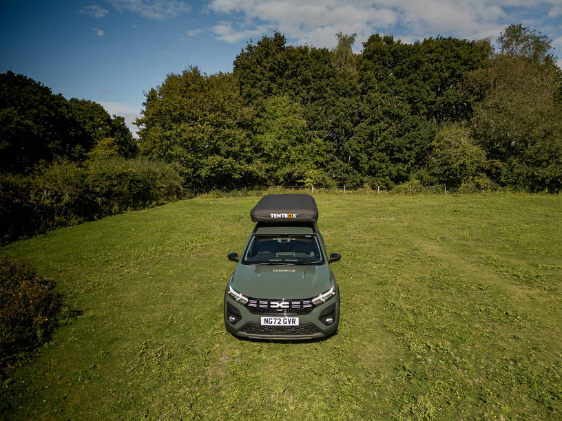 Zoomed out arial shot of a 4x4 style vehicle with a TentBox Classic on the roof, fitted with a protective cover