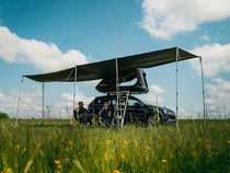 TentBox GO Tunnel Awning in Wing Mode, with two people sat underneath it