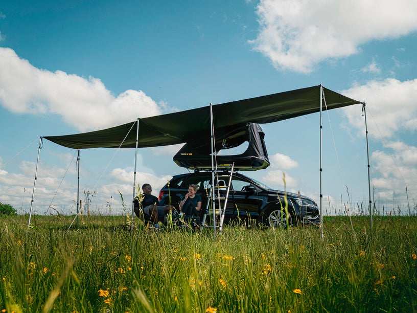 TentBox GO Tunnel Awning in Wing Mode, with two people sat underneath it