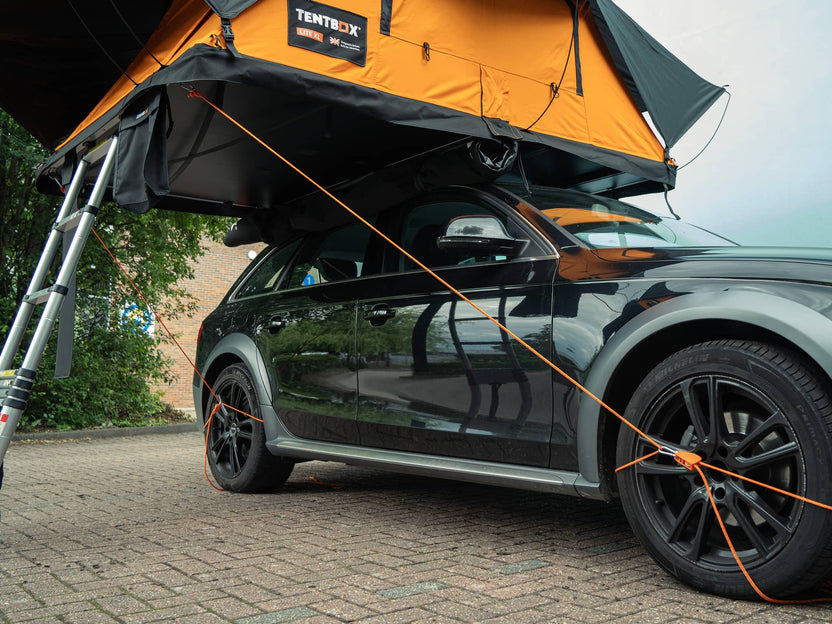 TentBox Guy Ropes shown on car, connected to wheel