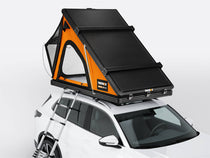 TentBox Cargo rooftop tent in Sunset colour on the top of a vehicle