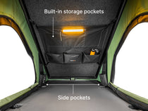  image showcasing the TentBox Cargo rooftop tent's built-in storage and side pockets