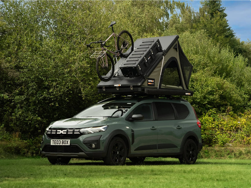 Cargo 2.0 tent shown mounted with both the rooftop tent and bike rack visible, reinforcing dual-use capability.

