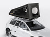 TentBox GO roof top tent attached to a white car with a ladder on a light grey background