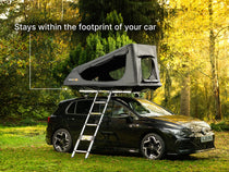  TentBox GO roof top tent on a car in a forest setting with text 'Stays within the footprint of your car'.
