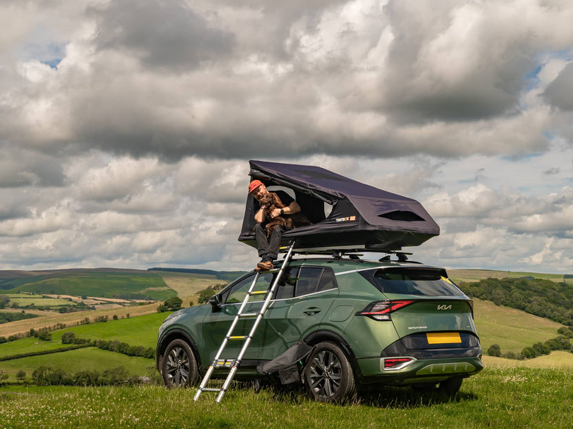 Man enjoying the views with his dog from inside the TentBox GO