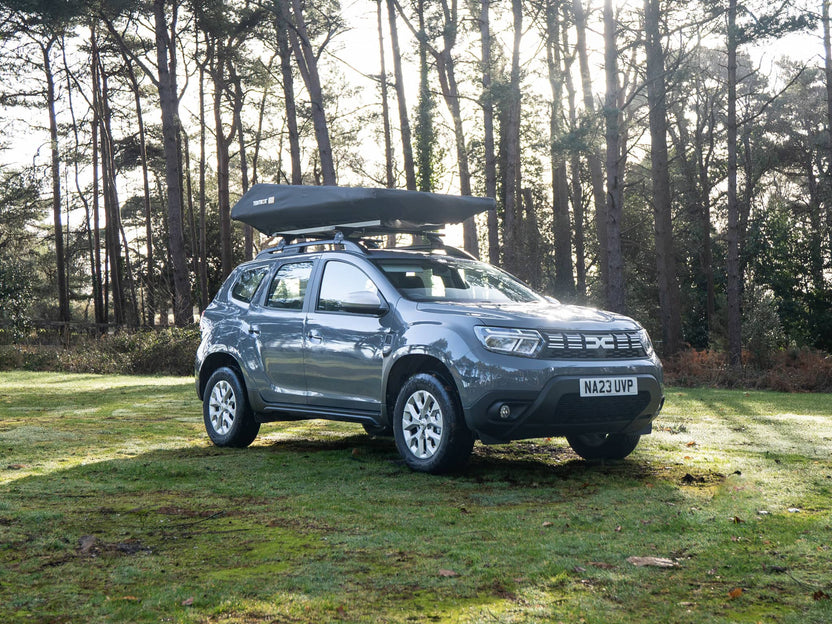 Closed view of the TentBox GO on top of a Dacia Duster in the woods