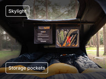Interior shot showing two sleeping bags, mesh storage pockets, and a skylight; captions: “Skylight” and “Storage pockets.”