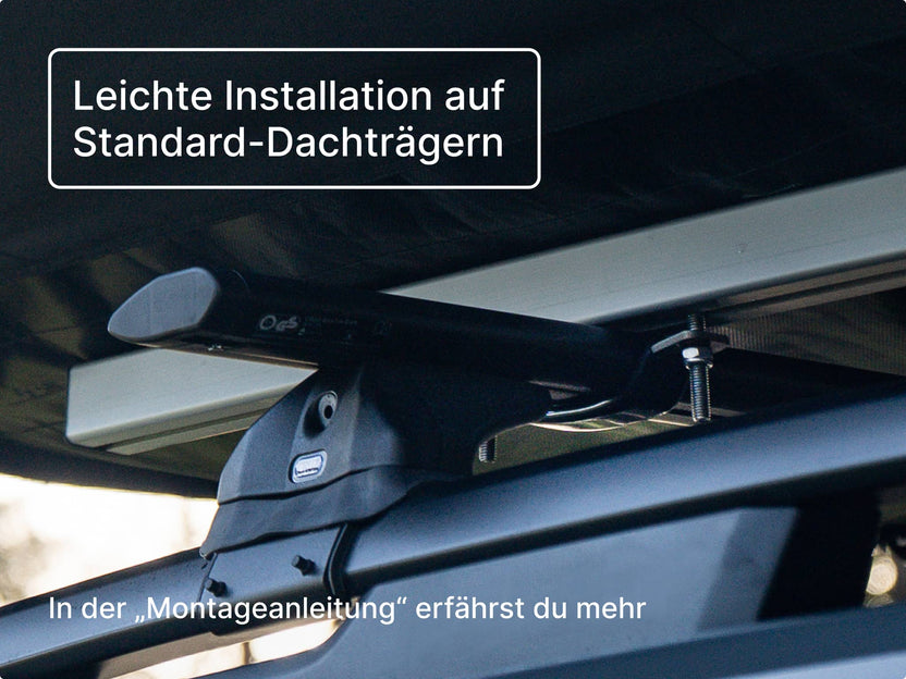 Nahaufnahme des GO Dachzelts, montiert auf Standard-Dachträgern, mit sichtbaren Schrauben und Halterungen; enthält einen Hinweis zum „Montage-Guide“.