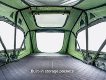  An image showing the internal large size and built-in storage pockets of the TentBox Lite roof tent 