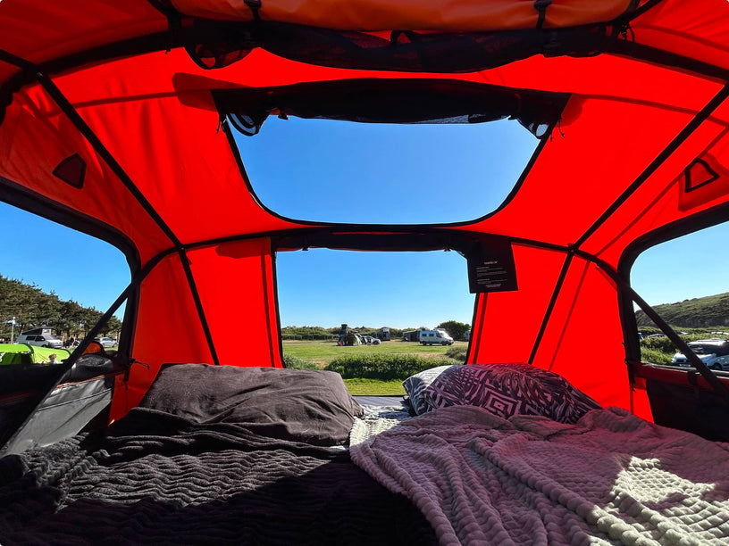 Interior view of TentBox looking up toward skylight; soft light and zipped windows visible