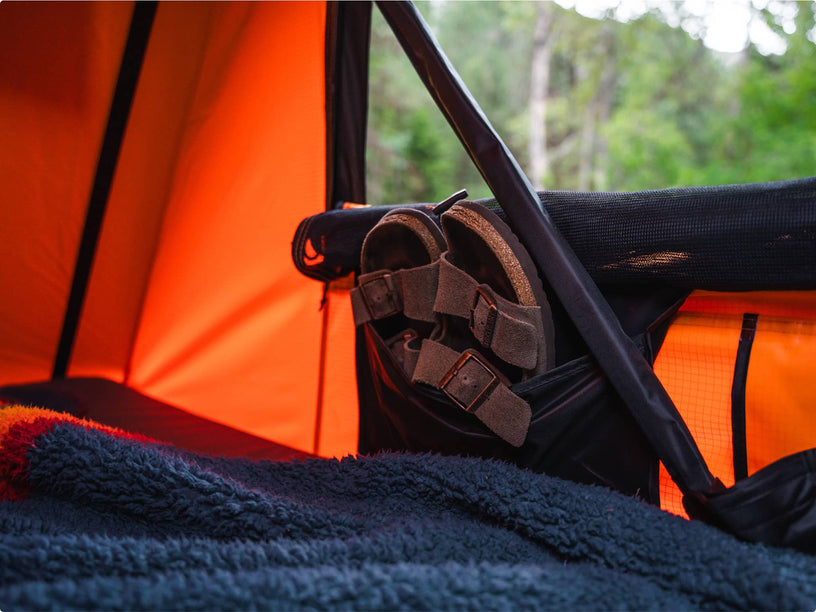 Close-up of storage area inside TentBox showing a shoe pocket next to the sleeping area.