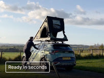 [img-en] Person climbing up the ladder into a green Cargo 2.0 rooftop tent mounted on an SUV.[autoplay]